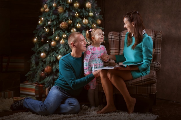 Young family near the Christmas tree