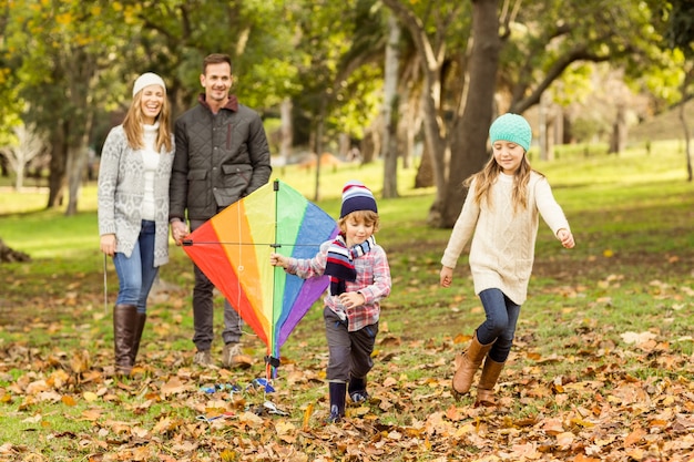 Young family playing with a kite