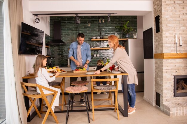 Young family preparing vegetables in the kitchen