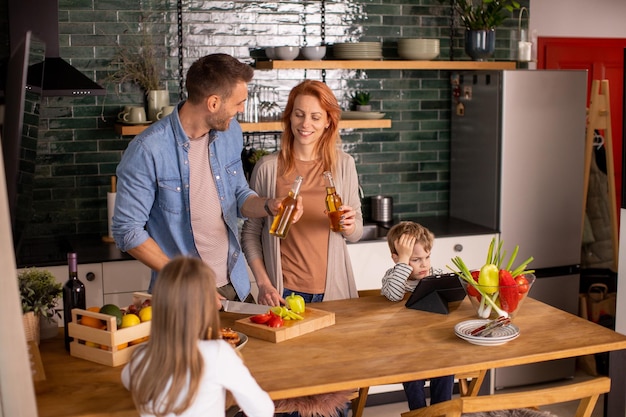 Young family preparing vegetables in the kitchen