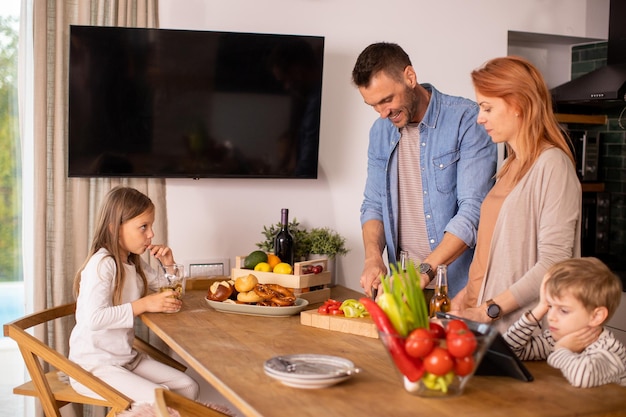 Young family preparing vegetables in the kitchen