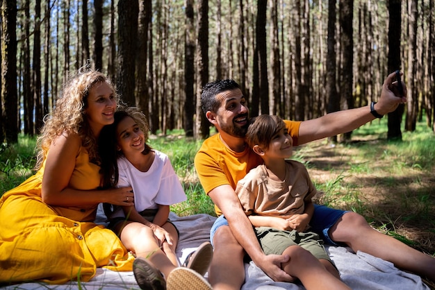 Young family spending good time together in woods Concept of close family relations