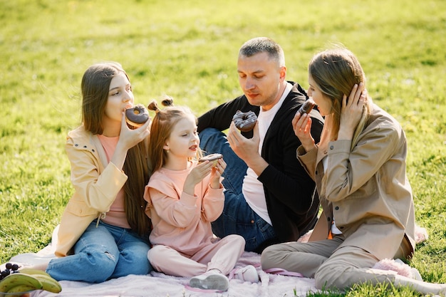 Young family spending time together and having a picnic in a park