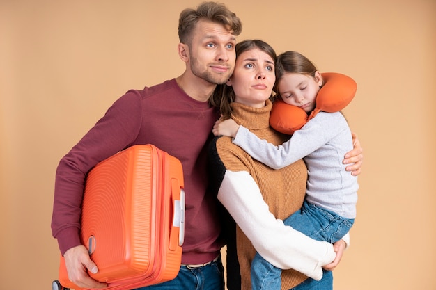 Young family of three posing together before travel vacation