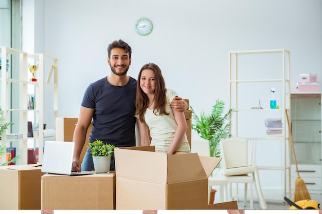 Young family unpacking at new house with boxes