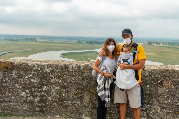 A young family visiting the famous Mont Saint-Michel Abbey from inside, in the Manche department, Normandy region, France