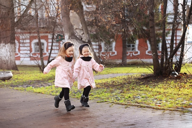 Young family on a walk in the autumn park on a sunny day. Happiness to be together.