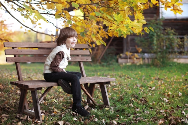 Young family on a walk in the autumn park on a sunny day. Happiness to be together.