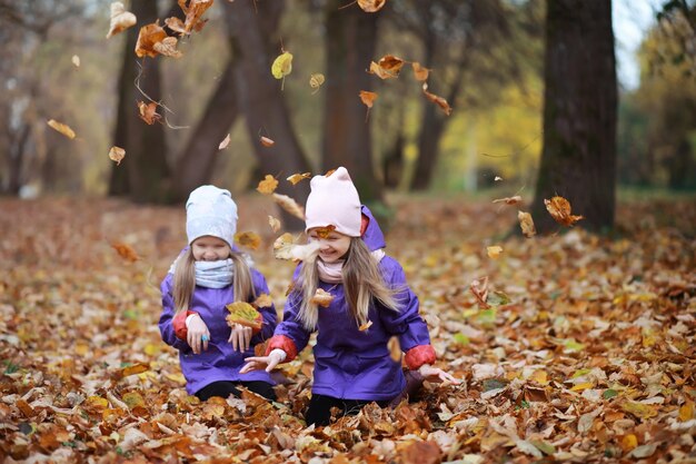 Young family on a walk in the autumn park on a sunny day Happiness to be together