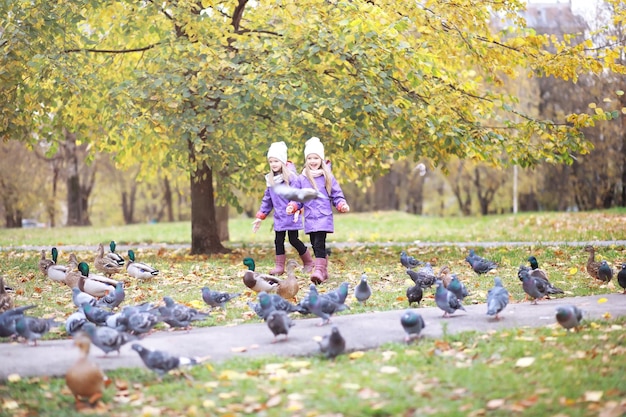 Young family on a walk in the autumn park on a sunny day Happiness to be together