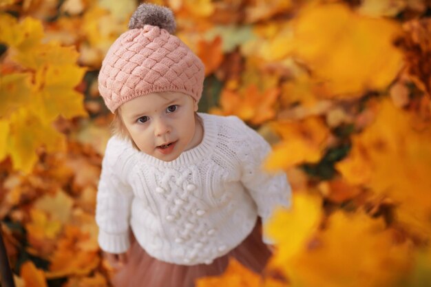 Young family on a walk in the autumn park on a sunny day happiness to be together