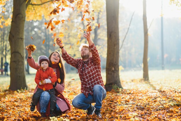 Young family walking in the park. Autumn.