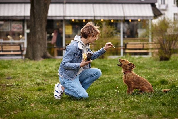 街の通りを犬と一緒に歩いている若い家族