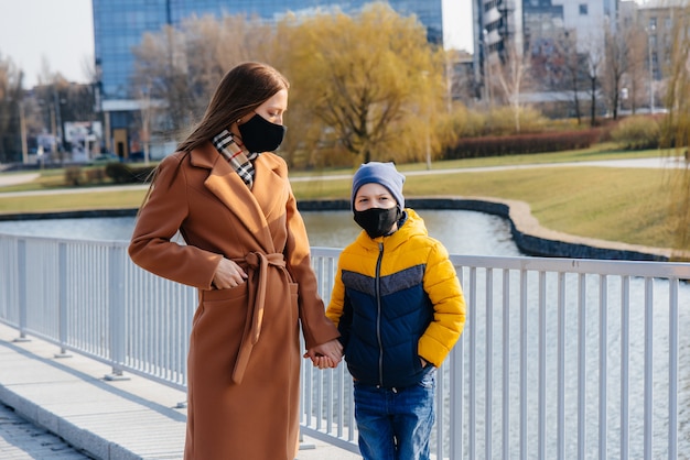 A young family walks and breathes fresh air on a Sunny day during a quarantine and pandemic.