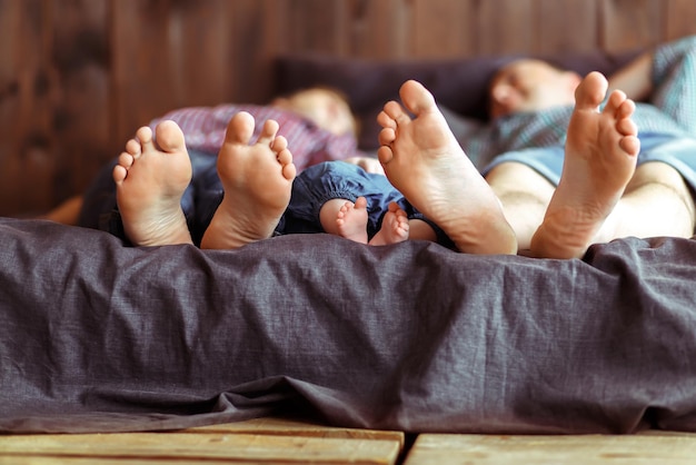 Young family with a baby, big feet