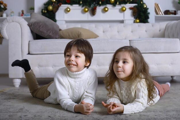 A young family with children decorates the house for the holiday New Years Eve Waiting for the new year