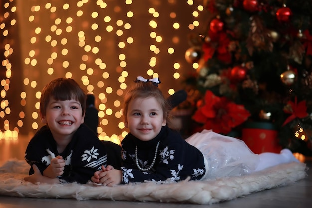 A young family with children decorates the house for the holiday New Years Eve