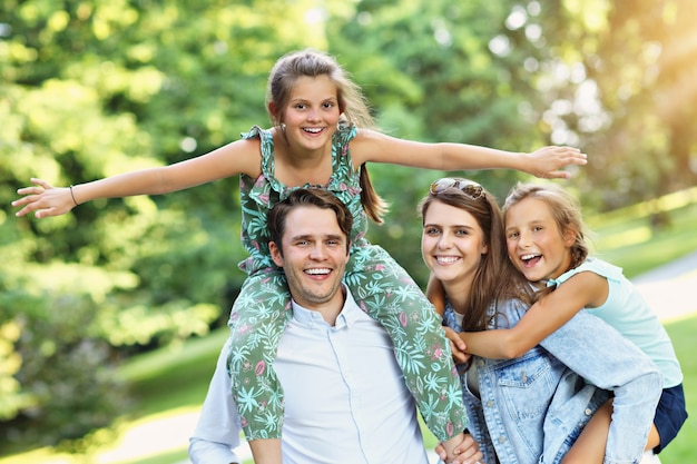 young family with children having fun in nature