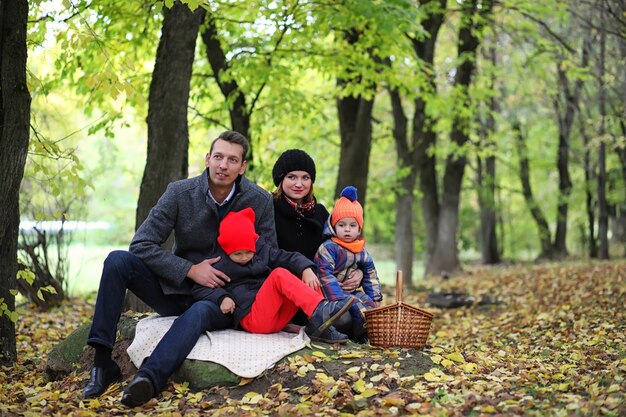 Giovane famiglia con bambini in una passeggiata nel parco in primavera