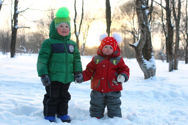 Young family with children on a walk in the park in winter