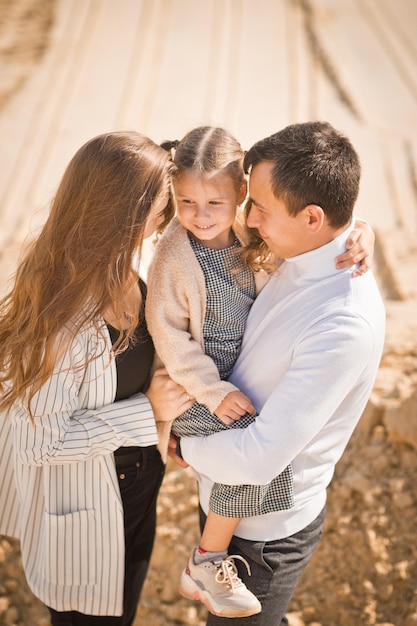 A young family with a daughter among the sand and blue sky 3306