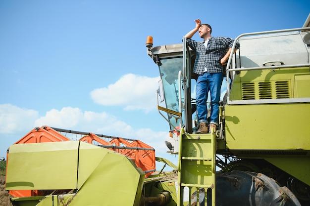 Young farmer on a break in combine after harvest