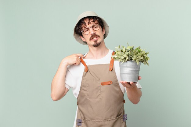 Photo young farmer man feeling stressed, anxious, tired and frustrated