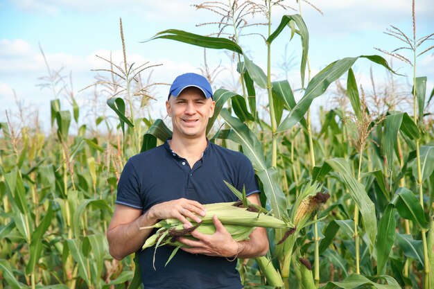 Young farmer standing on field during harvest