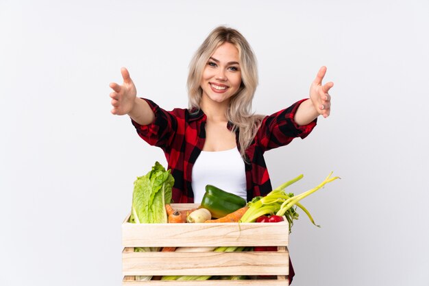 Young farmer woman over isolated wall