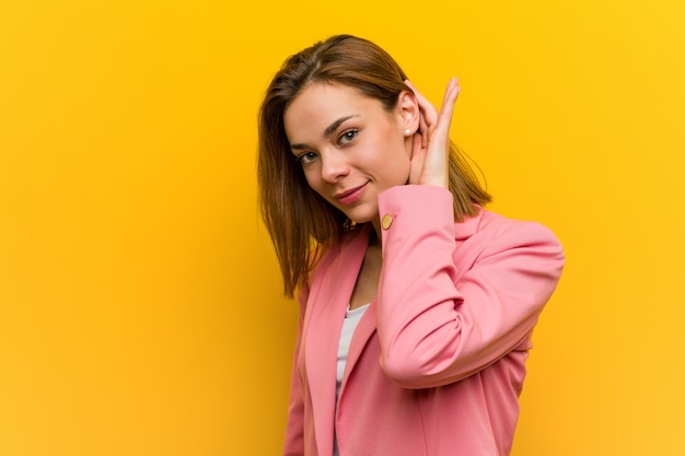 Young fashion business woman trying to listening a gossip.