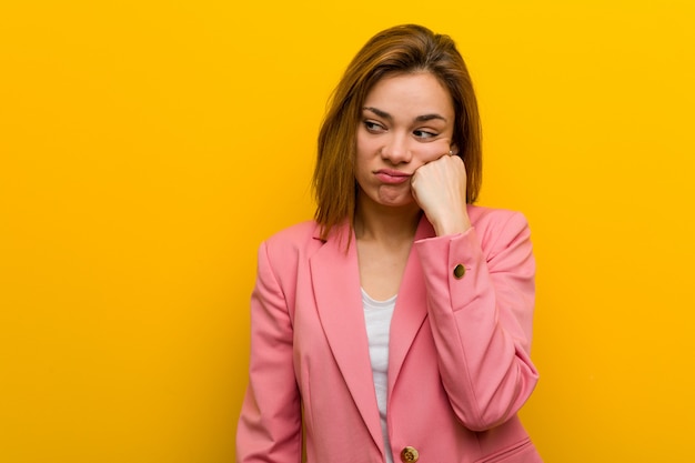 Young fashion business woman who feels sad and pensive, looking at copy space.