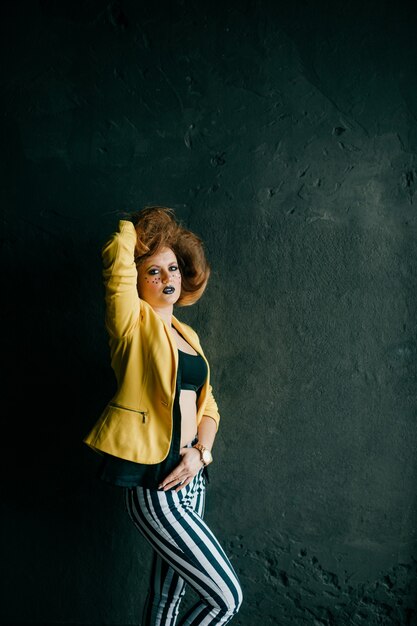 Young fashion clown girl posing in studio