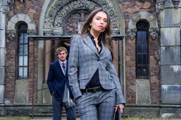 Young fashion couple pose outdoor in front of old building