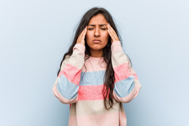 Young fashion indian woman touching temples and having headache.