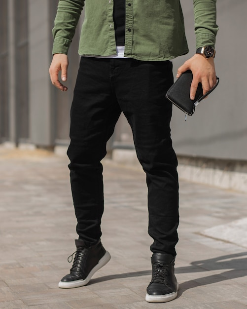 Photo young fashion mans legs with black sneakers black shoes