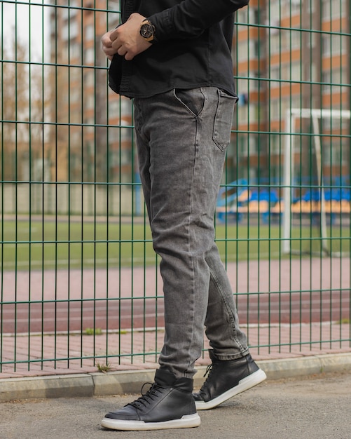 Premium Photo | Young fashion mans legs with black sneakers black shoes