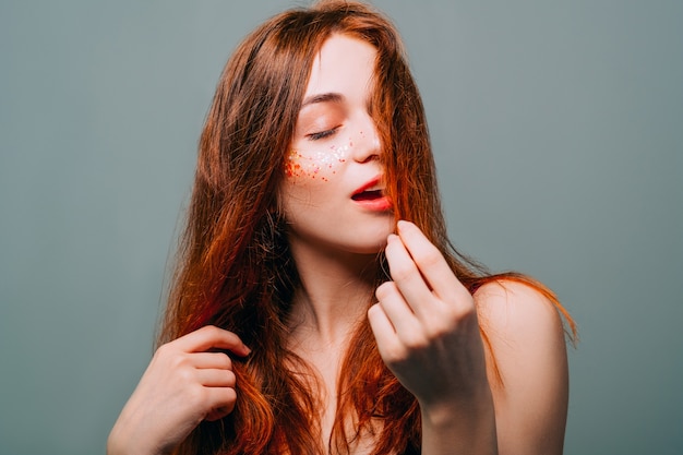 Young fashion model portrait. Redhead beauty. Woman with auburn hair