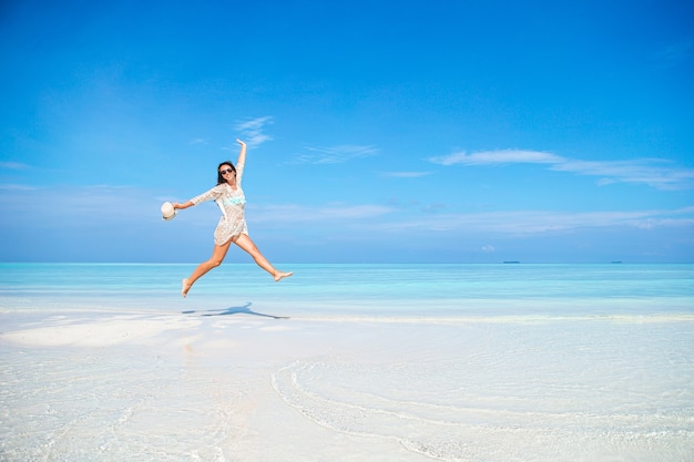 Young fashion woman in green dress on the beach