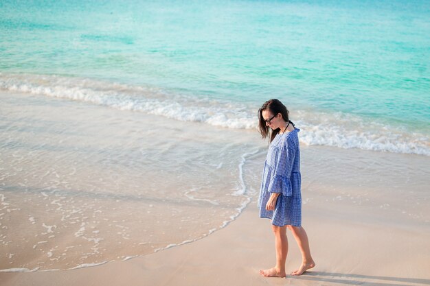 Young fashion woman in hat on the beach