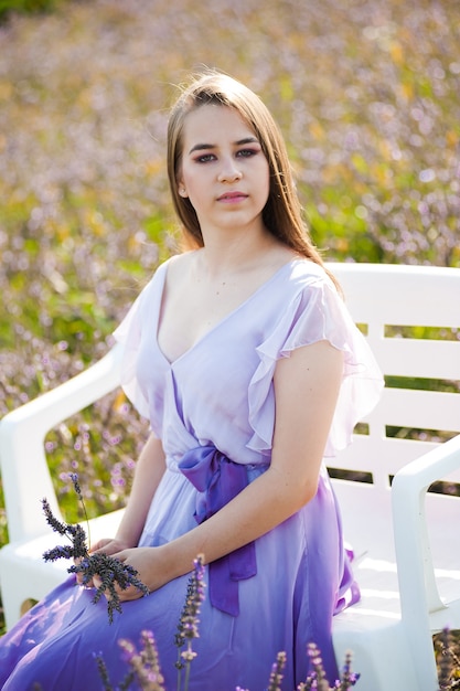 Young fashion woman in long dress outdoor lavender field