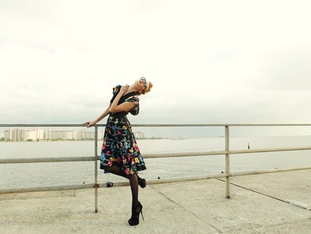 Young  fashion woman posing near the sea