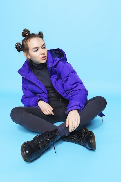 Young fashion woman in short violet down jacket and leather boots, asian fashion