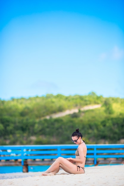 Young fashion woman in swimsuit on the beach