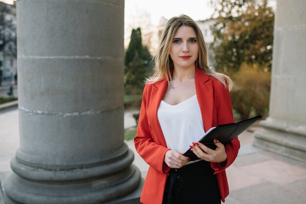 Young fashionable businesswoman with paperwork