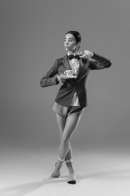 Young fashionable, stylish woman wearing jacket and socks working from home.