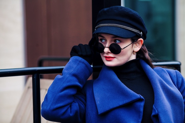 Young fashionable woman with sunglasses and hat