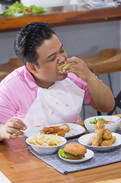 Young fat man eating