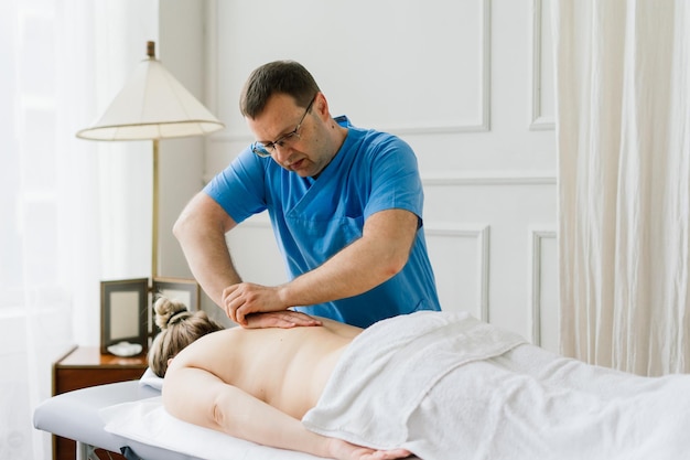 Young fat woman getting massage treatment in a day spa cabinet.