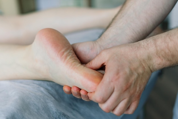 Young fat woman getting massage treatment in a day spa cabinet.