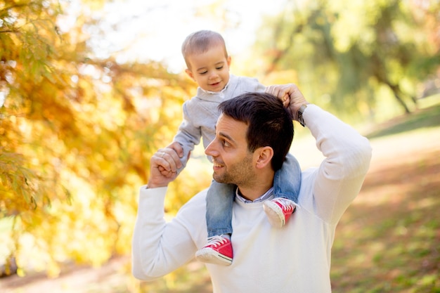 Young father and baby boy in autumn park